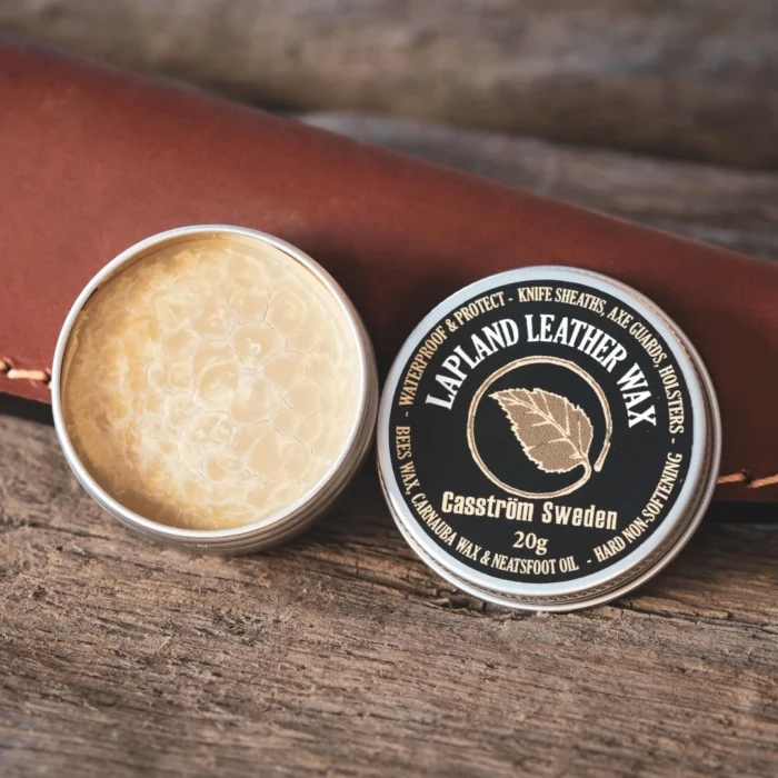 An open tin of Casström Lapland Leather Wax with a leather knife sheath in the background.