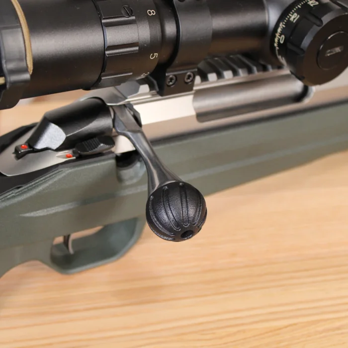 Tikka T3x with Bolt Knob - Helix Sphere, with wood in the background.